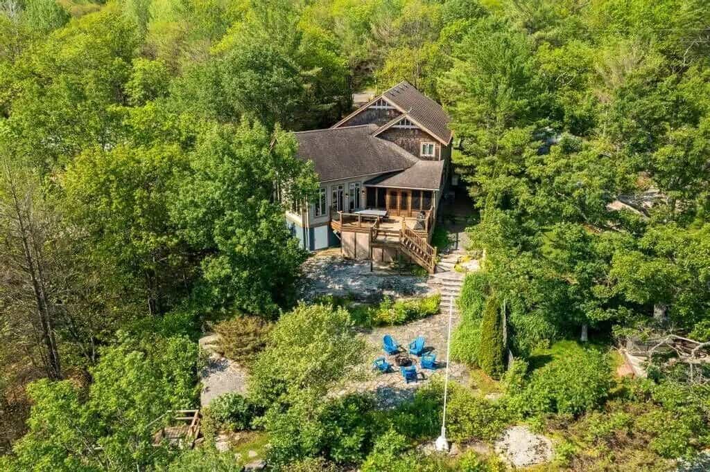 20 Top Airbnb Cottages in Muskoka for an Epic Getaway 50 Green pine and maple forest surrounding the Infinite Vacations with brown roof.