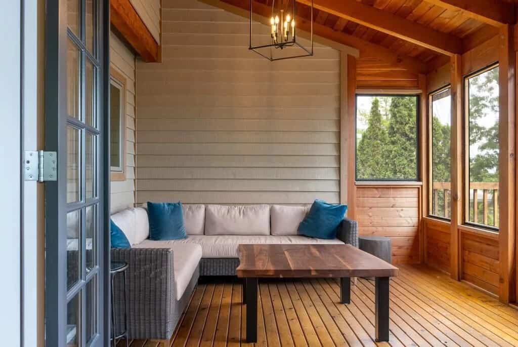 20 Top Airbnb Cottages in Muskoka for an Epic Getaway 51 Muskoka room at the Infinite vacation cottage. Wooden floors and ceiling with a cream couch.