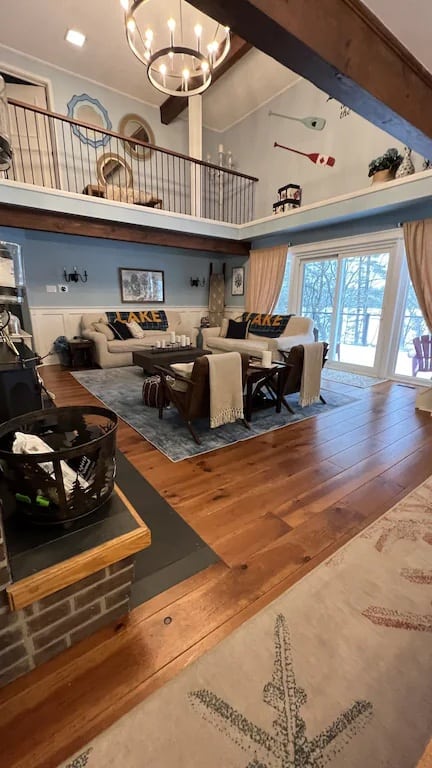 20 Top Airbnb Cottages in Muskoka for an Epic Getaway 55 Take a Week Off living room. White couches with "Lake" on blankets draped overtop. Wood floors with light blue walls.