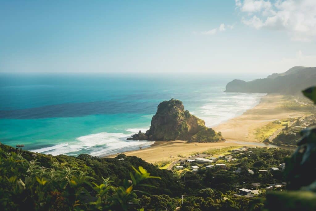 19 Pros and Cons of Living in Auckland NZ 3 Piha Beach, a part of western Auckland, that you can visit to surf while in New Zealand