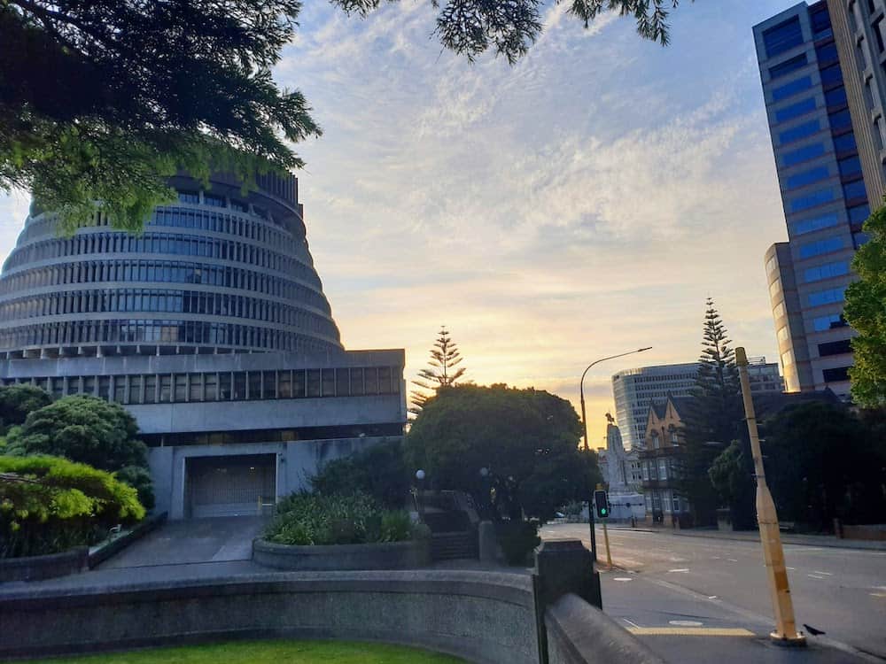 13 Best Places to Live in New Zealand (and Where Not To!) 2 Wellington's famous parliament, beehive, and the city streets at the golden hour.
