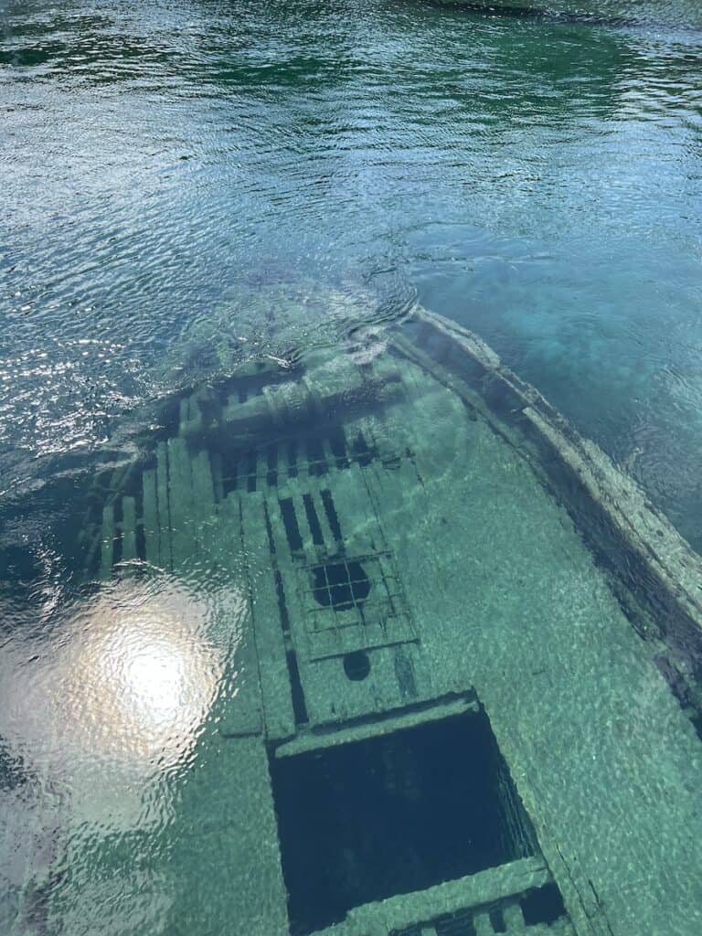 83 Bucket List Canada Things to Do in 2025 from a Canadian 3 Shipwreck beneath turquoise waters in Tobermory. It's an old steel ship that looks like the titanic but smaller.