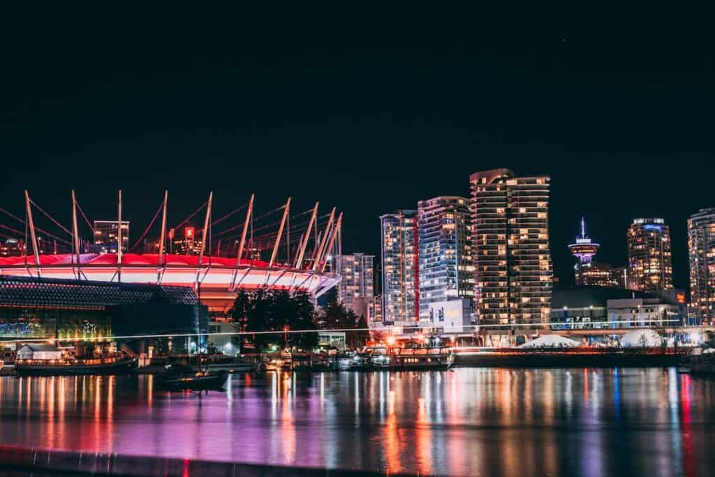 Living in Vancouver vs. Toronto: Where Should You Live? 5 Vancouver nightlife view of the harbour with the neon lights over the Pacific Ocean