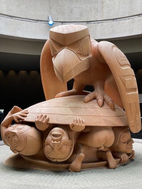 37 Amazing Vancouver Bucket List Things to Do 12 Statue from the Museum of Anthropology in Vancouver of an eagle on top of a clam shell with people inside, from an Indigenous artist.