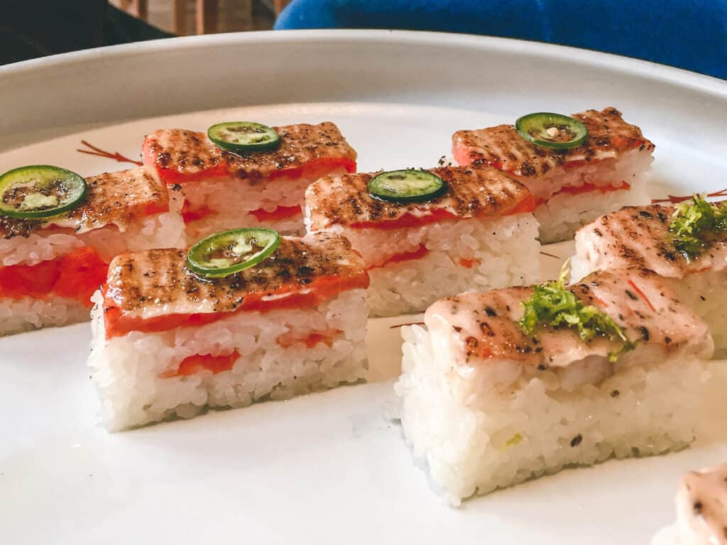 37 Amazing Vancouver Bucket List Things to Do 14 Seared salmon sushi on rice with a piece of jalapeno on top. From Miki in Vancouver.