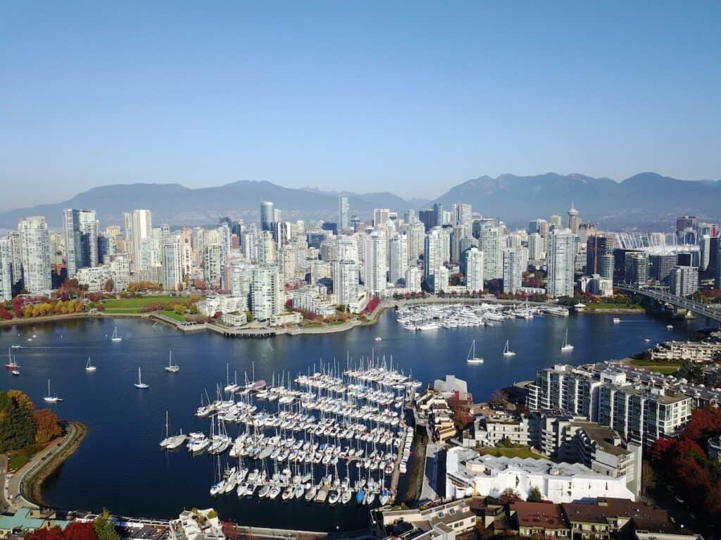 37 Amazing Vancouver Bucket List Things to Do 15 Aerial view of downtown Vancouver from a seaplane flight. You can see a fan of marina boats, the Rocky Mountains behind the skyscrapers, and the beautiful blue harbour.