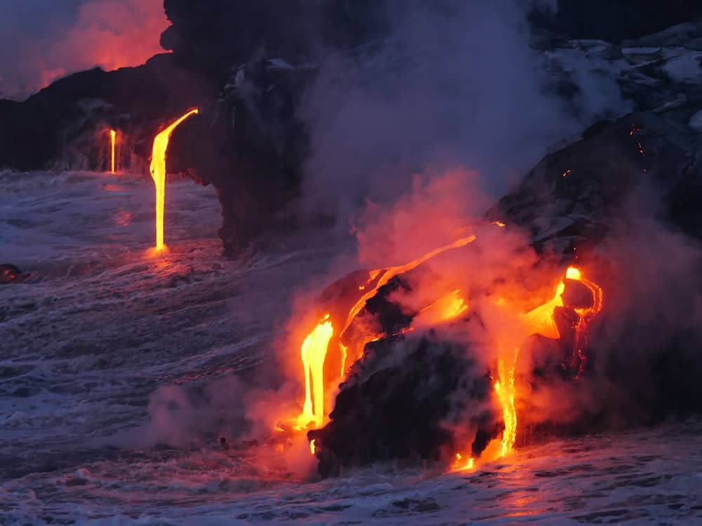 29 Pros and Cons of Living in Hawaii From an Expat 4 Lava flows with hot red lava flowing on black lava rock