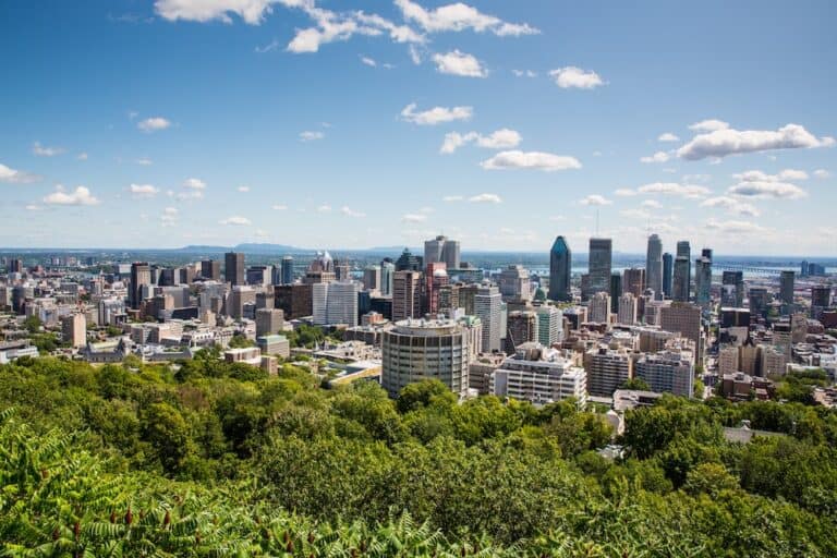What is the Cost of Living In Montreal in 2024? 27 Montreal scenic viewpoint over downtown Montreal with trees and then the distant skyscrapers
