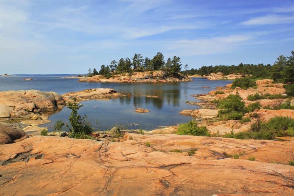 Killarney Provincial Park for back country camping in Ontario. Red rocks of the Canadian shield in front of Georgian Bay's blue waters.