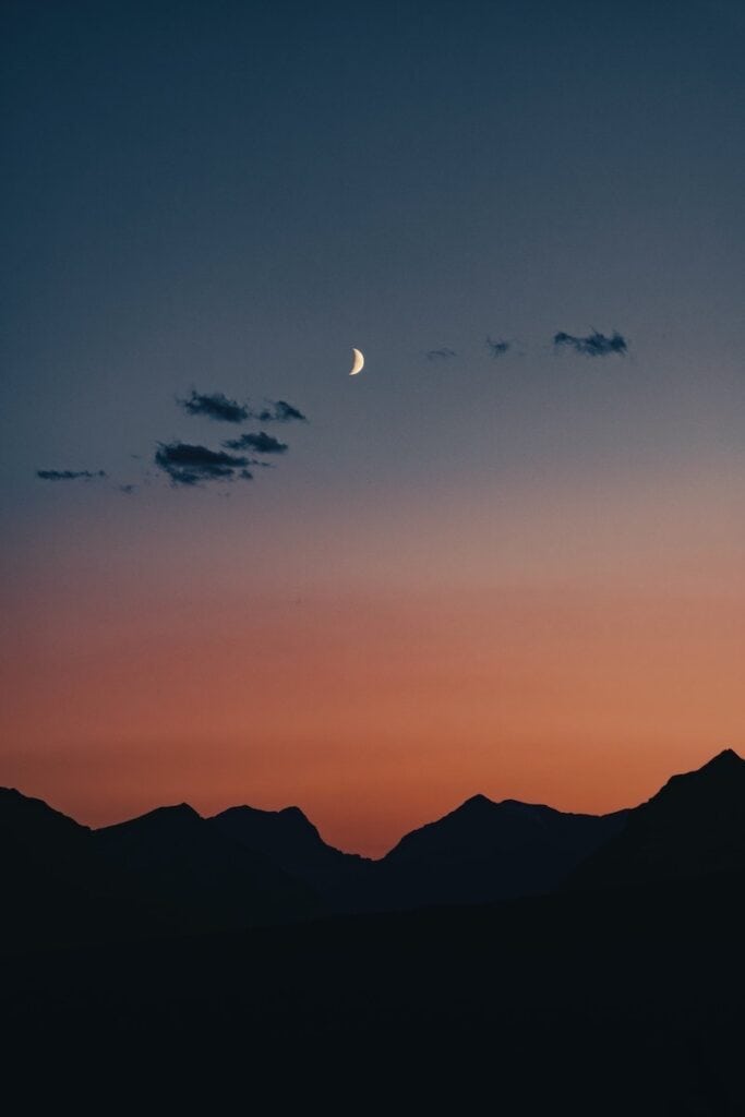 Banff National Park Itinerary: 1, 3, and 5 Day Guides 12 Beautiful silhouette of the mountains in Banff under the night sky and moon.