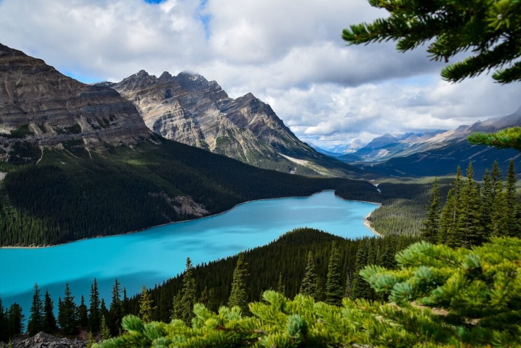Banff National Park Itinerary: 1, 3, and 5 Day Guides 7 Beautiful view of Peyto Lake with a clear sky surrounded by trees and mountains - a great location if you have a weekend in Banff.