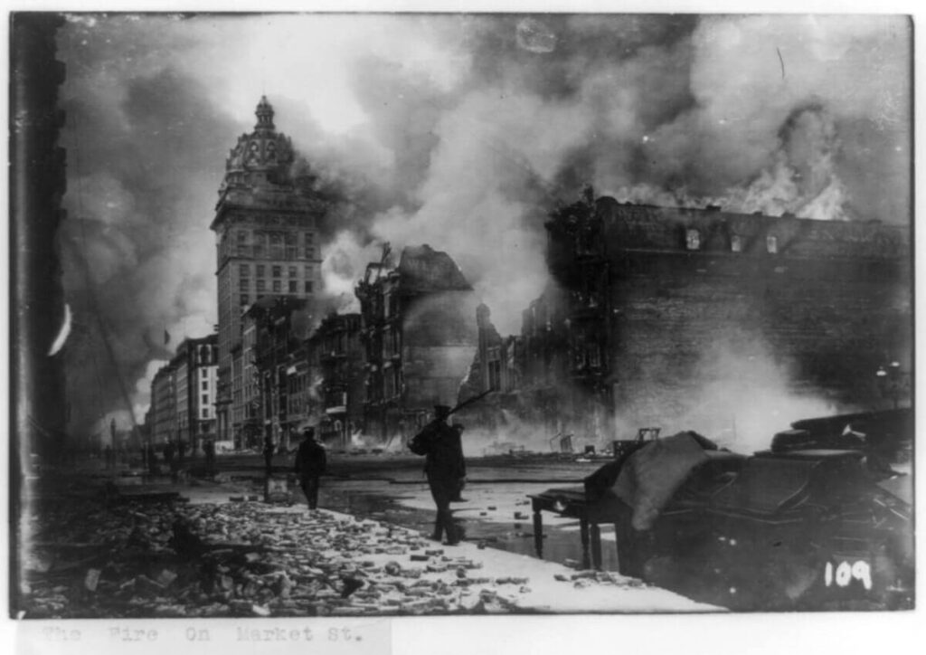 21 Pros and Cons of Living in California in 2024 3 An old photo in black and white of the earthquake aftermath in a street in California.