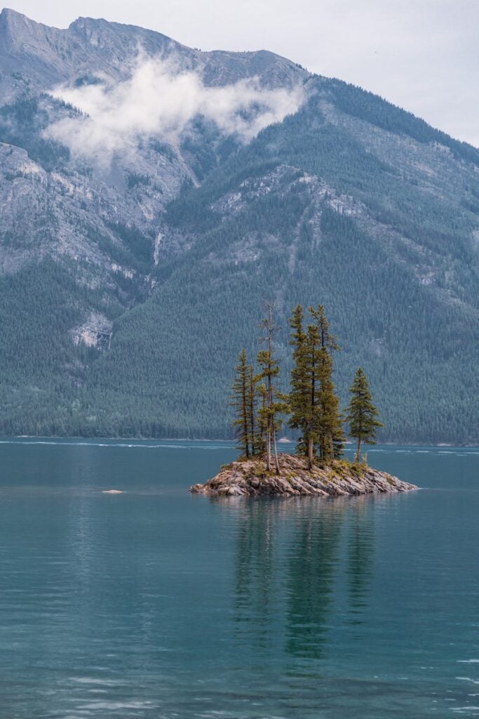 Banff National Park Itinerary: 1, 3, and 5 Day Guides 4 View from Lake Minnewanka, Banff, and the small island in the middle of it on a sunny day.