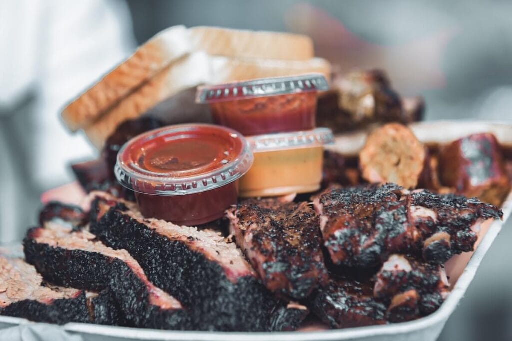 29 Pros and Cons of Living in Phoenix, Arizona 3 A full platter of well-done steak with sauces in a restaurant in Phoenix, something you'll get to enjoy if you decide to move to Phoenix.