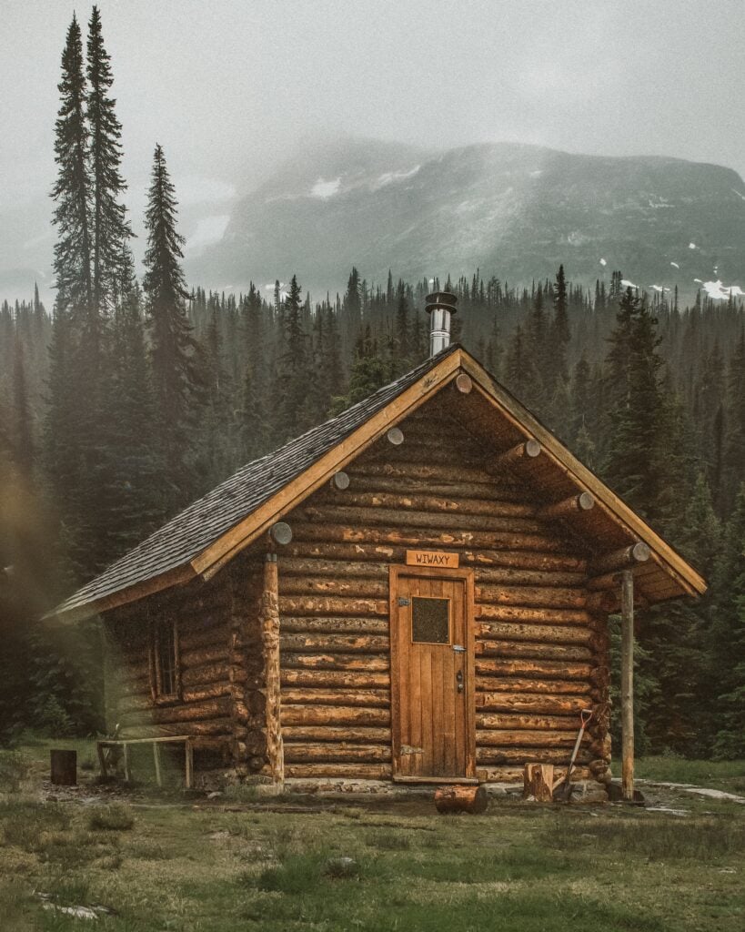 Where to Stay in Lake Louise Canada: 14 Best Hotels (2024) 3 A log cabin in the middle of the woods