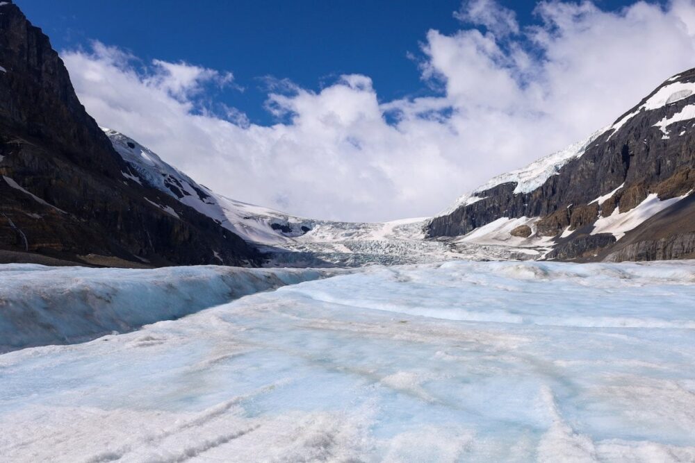 12 Best Jasper Helicopter Tours (2024) 13 A portion of land near mountains covered with snow. This is one of the destinations of the Complete Columba Icefield Helicopter Tours in Jasper.