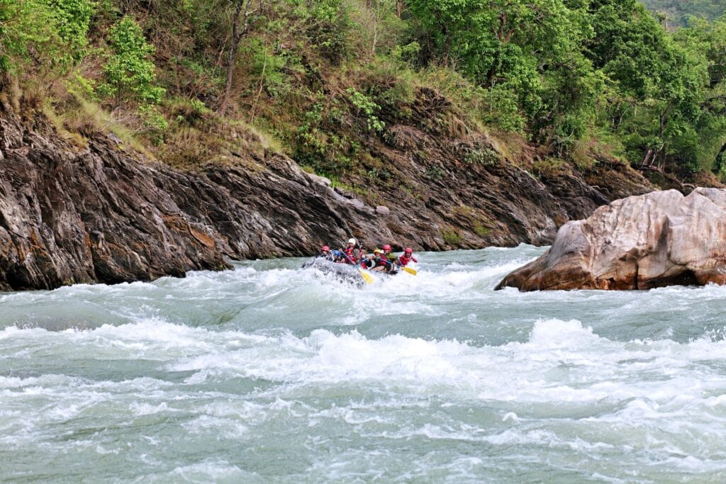 a group of people in a raft at kicking horse river