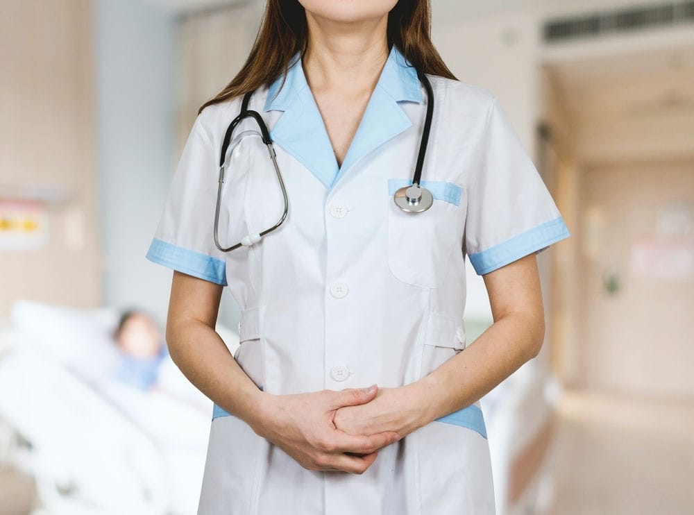 Living In Dublin 2024: The Complete Expat Guide 4 A woman wearing a white button up nurse unfiorm and a stethos cope hanging on her neck. Usually, healthcare in Ireland is very affordable.