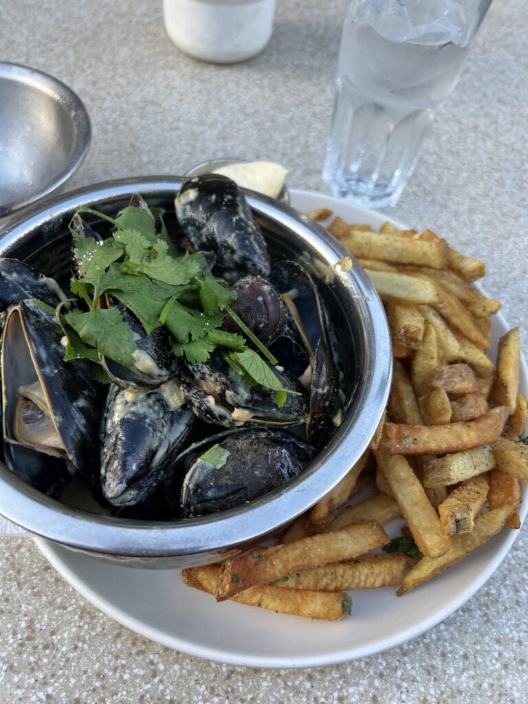 23 Best Things to Do in Deep Cove, BC 2024 8 Mussels in a metal bowl with fries on the side from Deep Cove's Arms Bistro