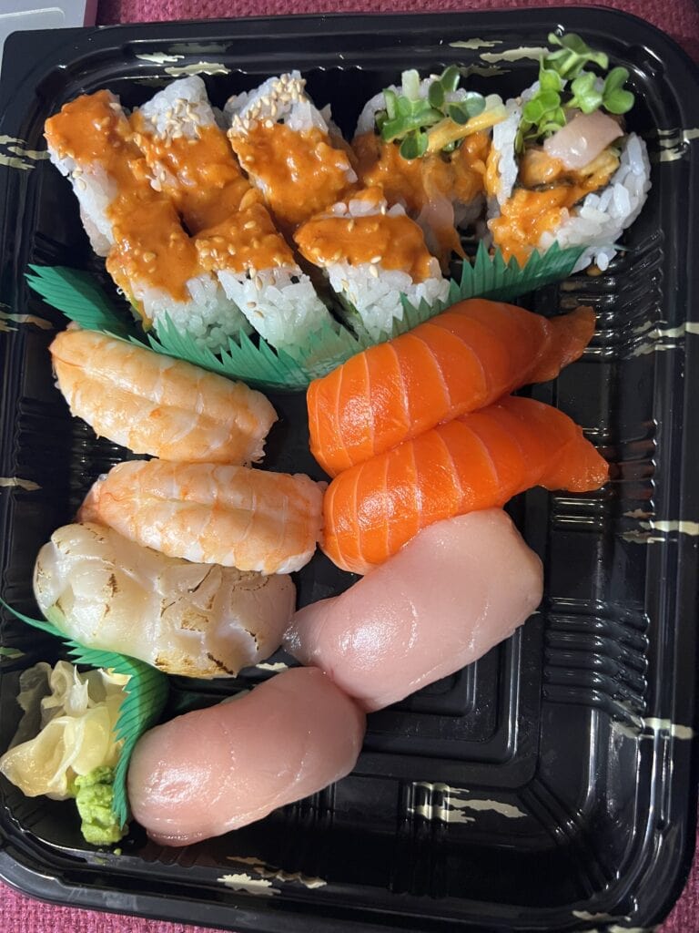 23 Best Things to Do in Deep Cove, BC 2024 15 Osaka sushi from Deep Cove. Spicy tuna roll, shrimp and salmon sushi on a tray.