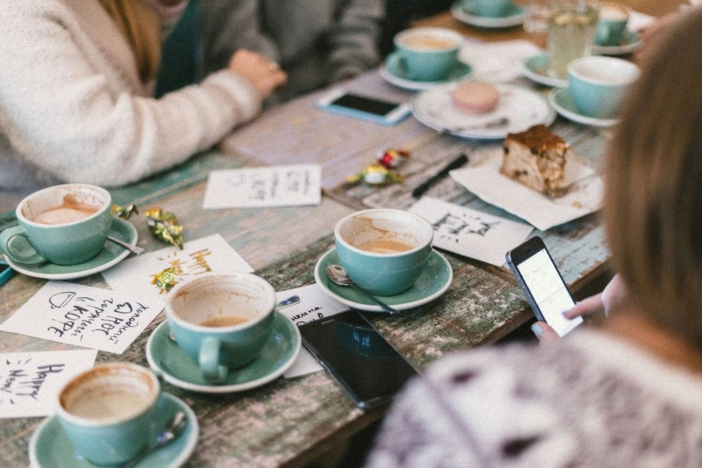 19 Pros And Cons Of Living In Wellington New Zealand 6 Cups of coffee on saucers placed on a wooden table. There are a lot of quirky cafes and restaurants to choose from in Wellington.