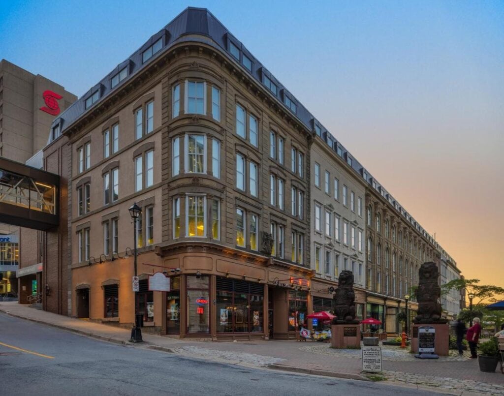 Where to Stay in Halifax: 17 Best Hotels in 2024 5 A photo of a brown building with windows lining up from the first to the fourth floor of the building. It is nea the street and has intricate designs. This is the Barrington Hotel one of the options if you're wondering where to stay in Halifax.