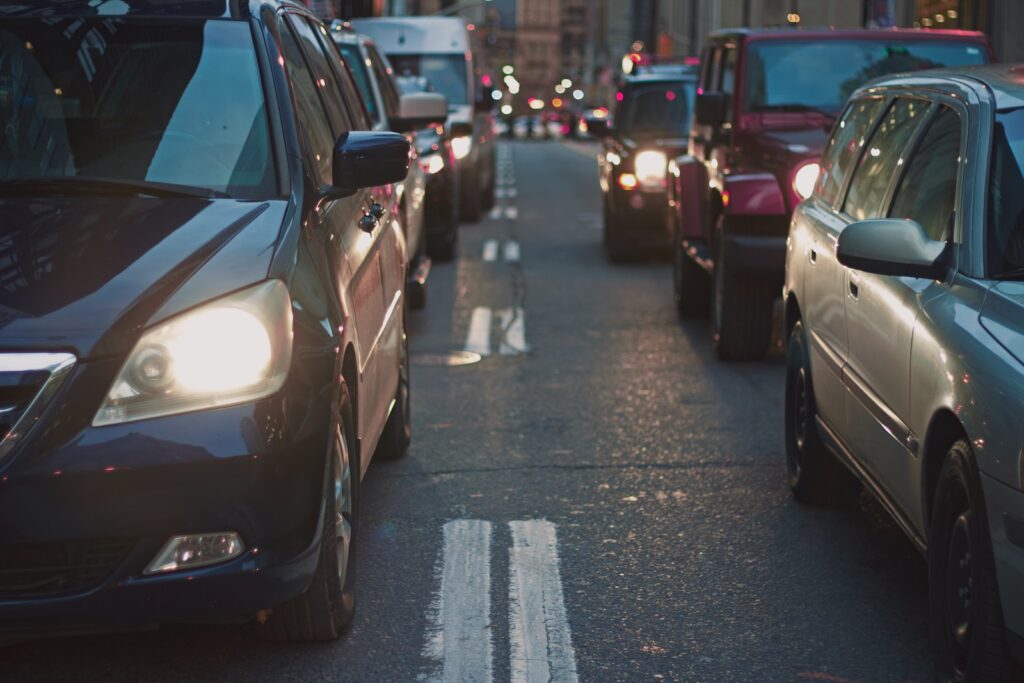 23 Top Pros and Cons of Living in Miami in 2024 5 Different types and colors of cars lining up on a highway. One of the cons of living in Miami is the terrible traffic.