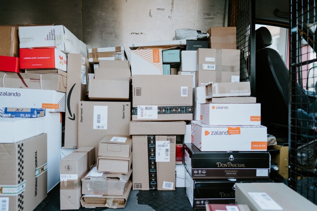 25 Pros and Cons of Living in Costa Rica in 2024 9 Packages in the back. ofa mail truck with Amazon and other online shopping