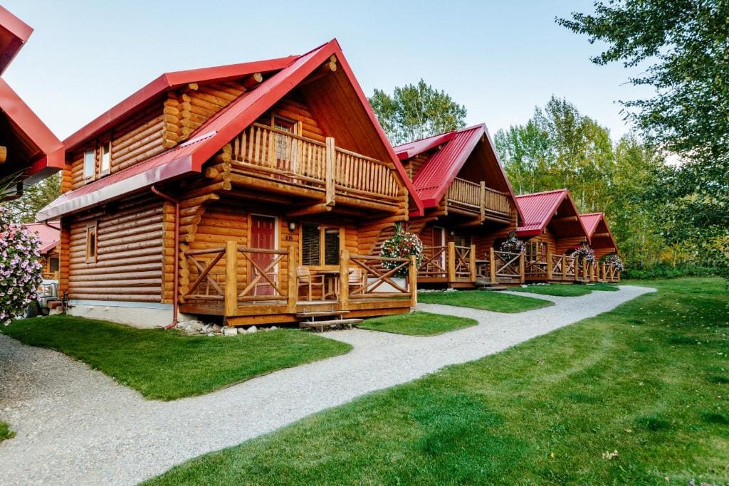 Where to Stay Near Jasper National Park: 16 Best Hotels 16 Wooden two-torey houses near grassy fields and trees. This the Miette Mountain Cabins in Jasper National Park.