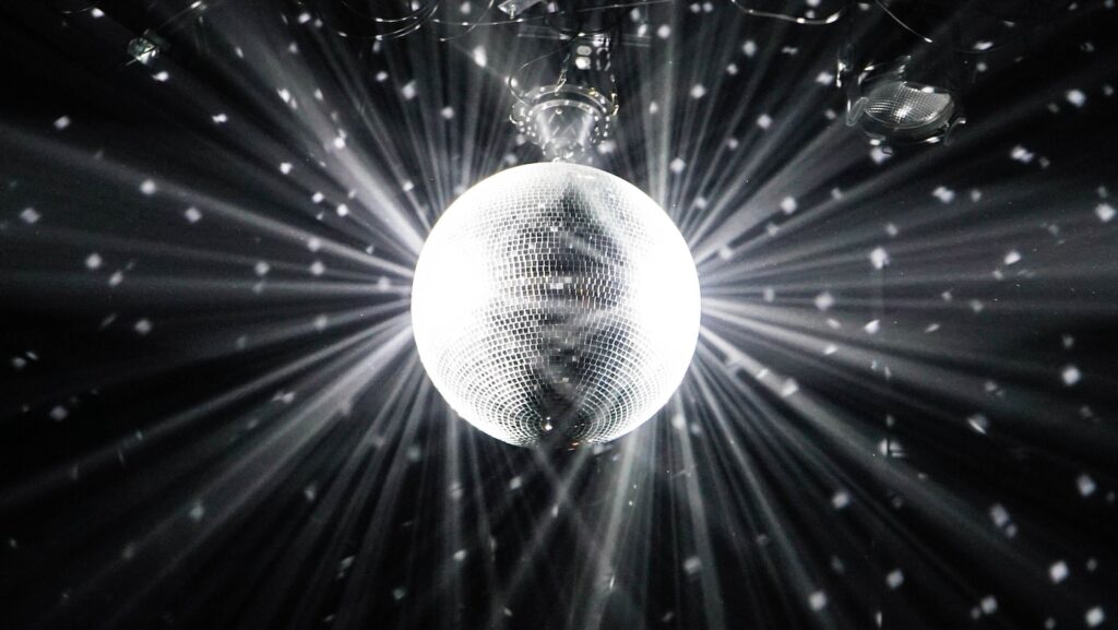 15 Pros And Cons Of Living In Madrid (By an Expat) 5 A photo of a discoball hanging from the ceiling in black background. Catch this sight by experiencing the lively nightlife of Madrid!