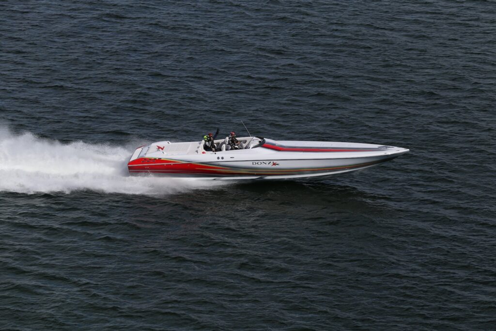 23 Top Pros and Cons of Living in Miami in 2024 11 White and Red Speedboat in the middle of a body of water. Miami is filled with many adventures including speedboating, swimming, and surfing!