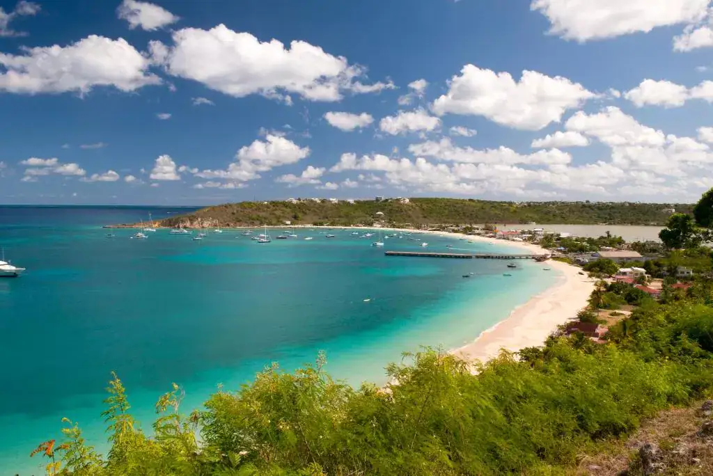 13 Best Hotels in Old San Juan, Puerto Rico 2024 15 A large body of clear blue water and a seashore near green trees and a dock. Different types of boats can also be seen in the water. This is the Marina San Juan, just 4 minutes away from SJ Suites, a hotel in Old San Juan.