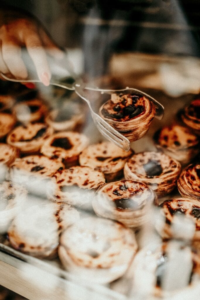 33 Living in Portugal Pros and Cons from an Expat 5 Portuguese custard tarts in a window display