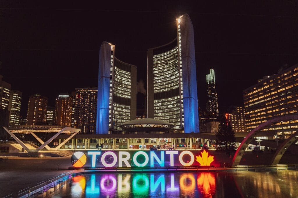 10 Best Hotels with Waterslides in Toronto 1 High-rise buildings near body of water during the night. A large light up sign spelled as TORONTO can also be seen. The Chelsea Hotel is located in this Downtown Toronto.