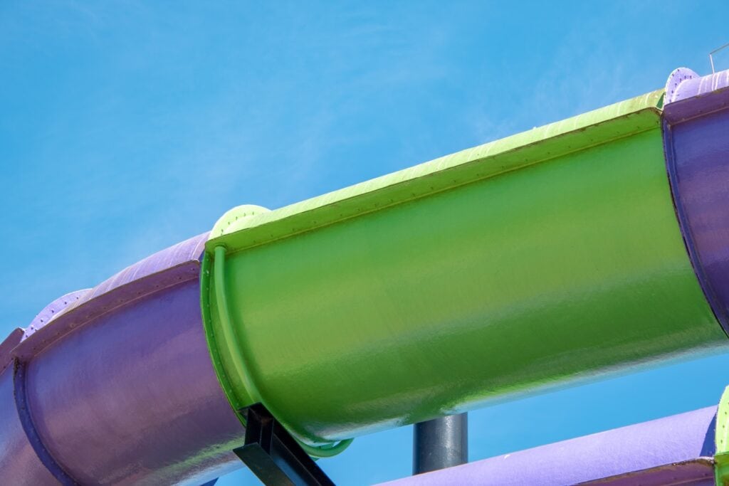 10 Best Hotels with Waterslides in Toronto 3 A large green and violet tube-like structure under a blue sky, This is a waterslide in the Deltaby Marriott Toronto East, a sister hotel of the Delta Hotels by Marriott Toronto Airport & Conference Centre.