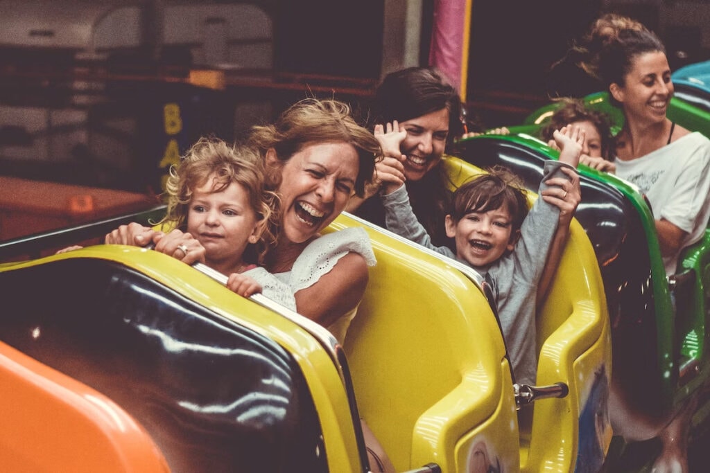 17 Best Day Trips From Niagara Falls (2024) 5 Three mothers sitting in a roller coaster cart with their children. Experience a thrilling ride in the Six Flags Darien Lake near Niagara Falls.