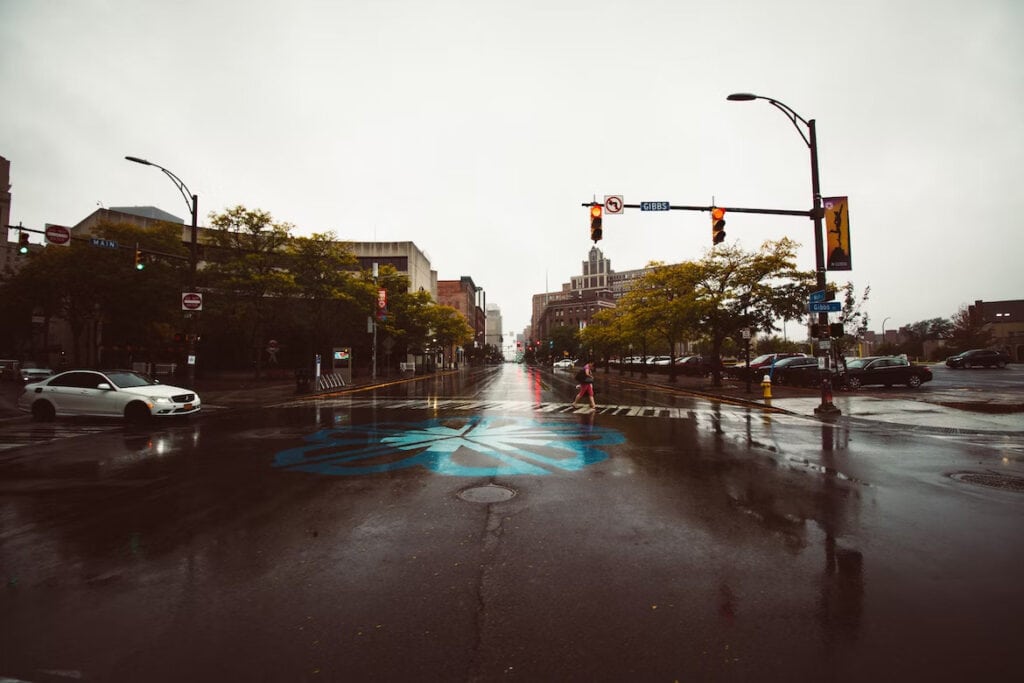 17 Best Day Trips From Niagara Falls (2024) 7 A wet crossroad with traffic lights under a gloomy sky. This is in Rochester one of the best destinations for the best day trips from Niagara Flls.