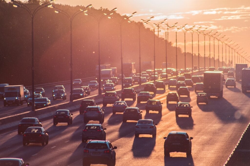 25 Pros and Cons of Living in New Hampshire in 2024 4 Cars lining up the highway keeping a safe distance from one another. A center island with lamp posts can also be seen dividing the two road directions. The lack of public transport in the state is one of the cons of living in New Hampshire.