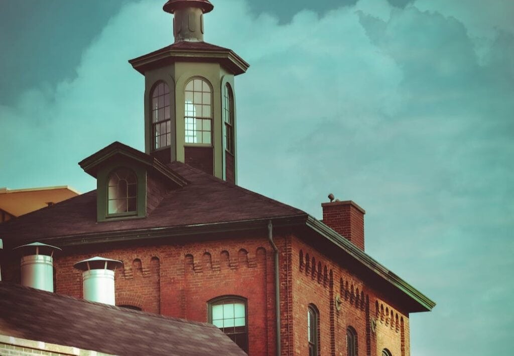 3 Best Segway Tours in Toronto in 2024 6 A brick building with triangular shaped roofs and a small tower on top of it. This is in the Distillery District Segway Ghost Tour.