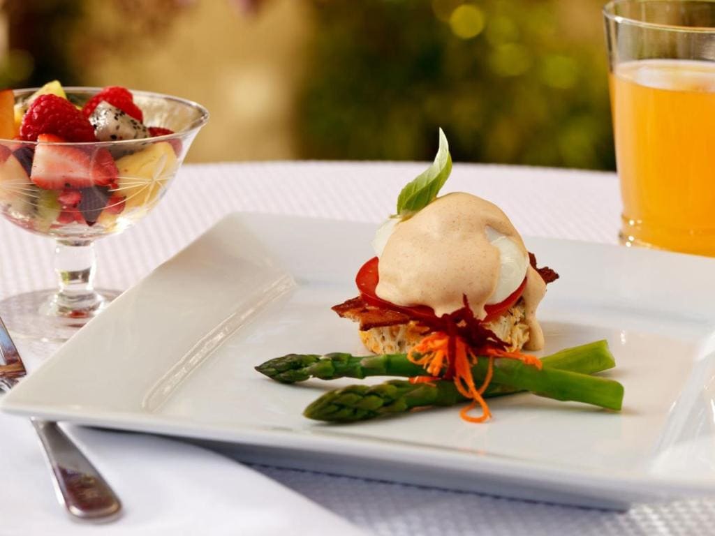 21 Best Places To Stay In Victoria, Canada 2024 16 A square plate with a fancy asparagus dish beside a fruit bowl and a glass of orange juice. Get a taste of this in the Abbeymore Manor.