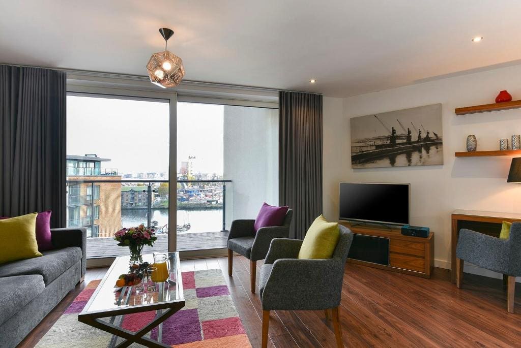 27 Best London Hotels with Balconies 2024 25 A living room with a view of the city.