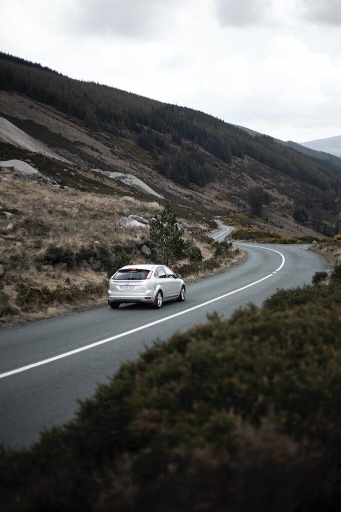 Renting a Car in Ireland: Top Things To Know in 2024 6 photography of moving silver sedan on road in Ireland