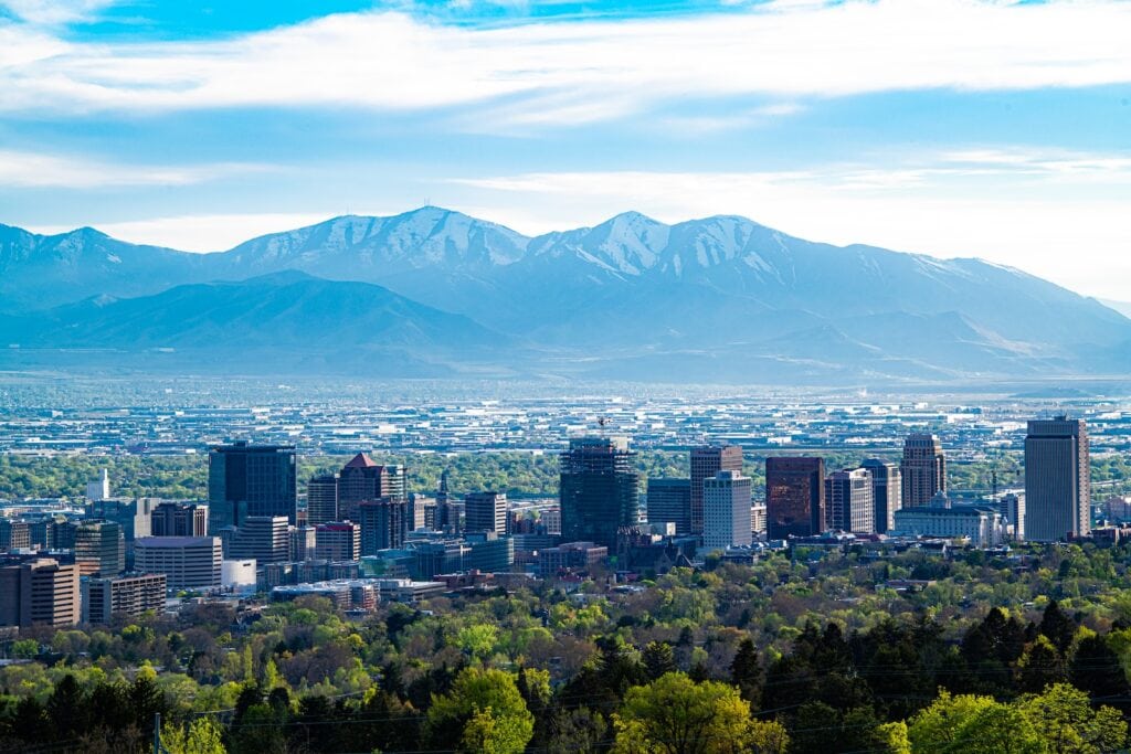 25 Pros and Cons of Living in Utah 2024 4 city skyline across green mountain during daytime