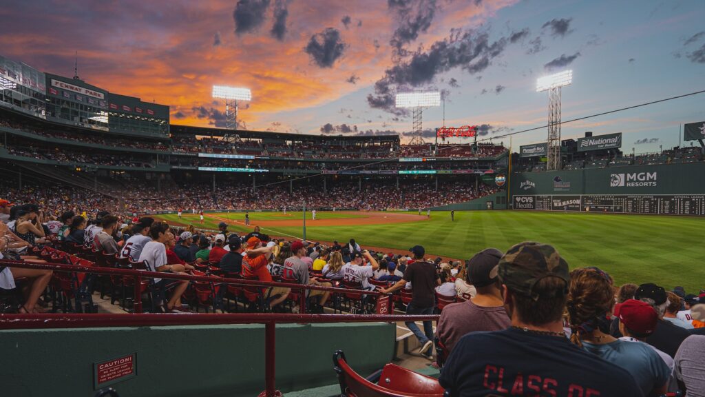 25 Pros and Cons of Living in Boston in 2024 4 people watching football game during daytime