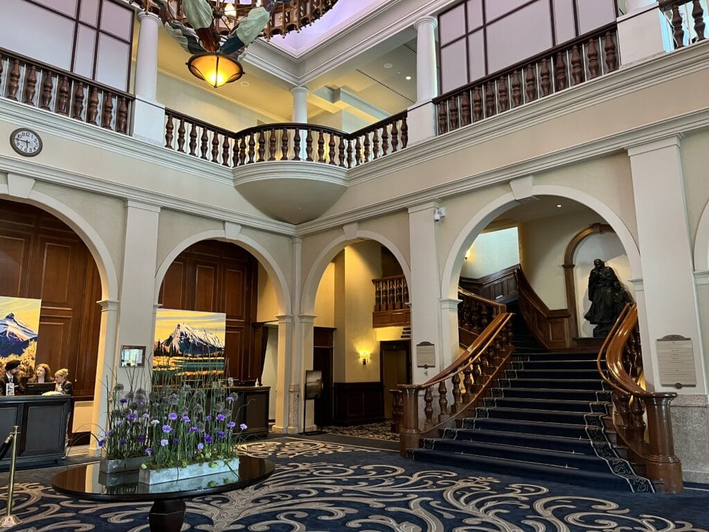 13 Best Banff Canada Luxury Resorts for 2024 10 Grand staircase inside the Fairmont Chateau Lake Louise janet crandal