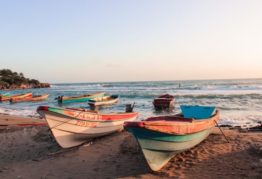 These Were the Most Popular Travel Destinations in 2023, According to Google Trends 1 white and blue boat on beach during daytime in Jamaica.