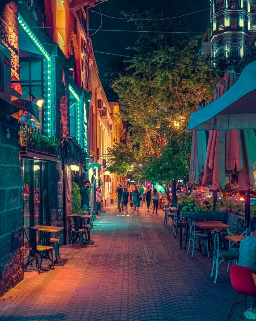 14 Top Freelance Visa Countries To Live And Work In 2024 11 The colorful streets at Armenia during night. There are tables and chairs outside and people walking in the streets.
