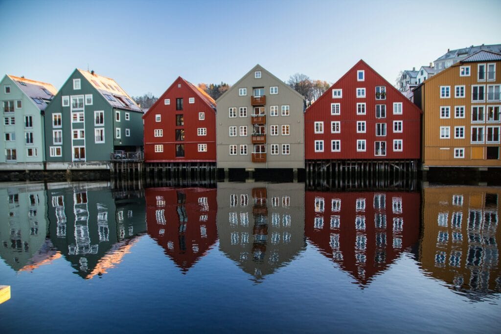 14 Top Freelance Visa Countries To Live And Work In 2024 10 Different colored buildings by the water in