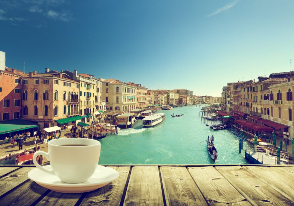 Things I Took For Granted Until I Moved to Italy 3 Coffee on table and Venice in sunset time, Italy overlooking gondoliers on the canal.