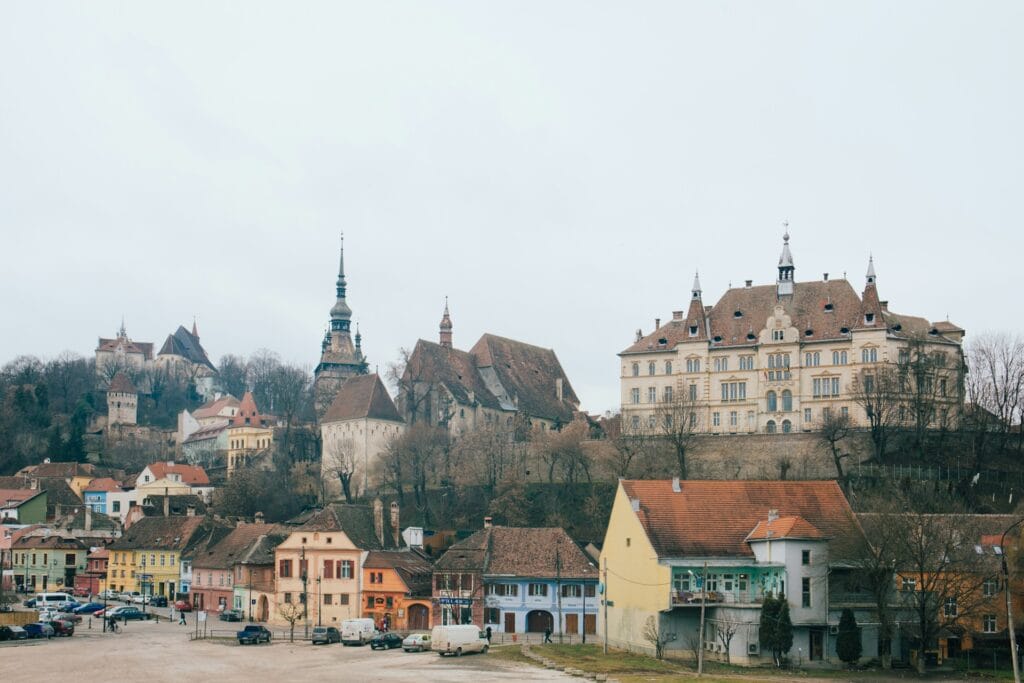 ALL European Countries With Digital Nomad Visas (2024) 17 Small colorful buildings with huge old buildings in Romania.
